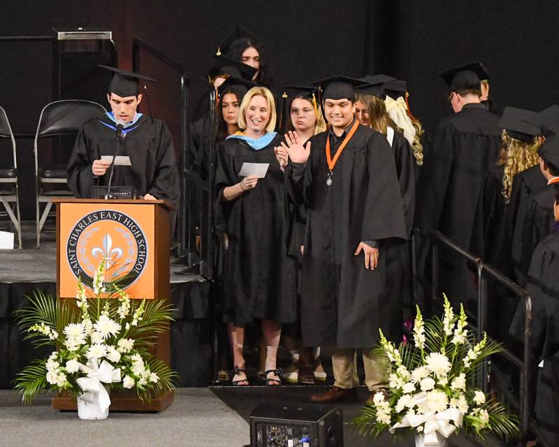 A St. Charles East graduate waves from stage before accepting his diploma on Monday, May 18, 2026, held at the Convocation Center in DeKalb.