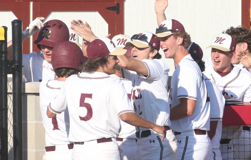 Members of the Morris baseball team hi-five teammates after defeating L-P 10-7 during the Class 3A Regional semifinal game at Huby Sarver Field in La Salle.