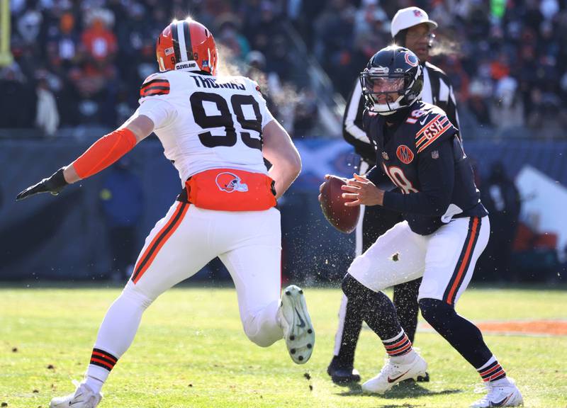 Chicago Bears quarterback Caleb Williams tries to avoid the pass rush of Cleveland Browns defensive end Cameron Thomas during their game Sunday, Dec. 14, 2025, at Soldier Field in Chicago.