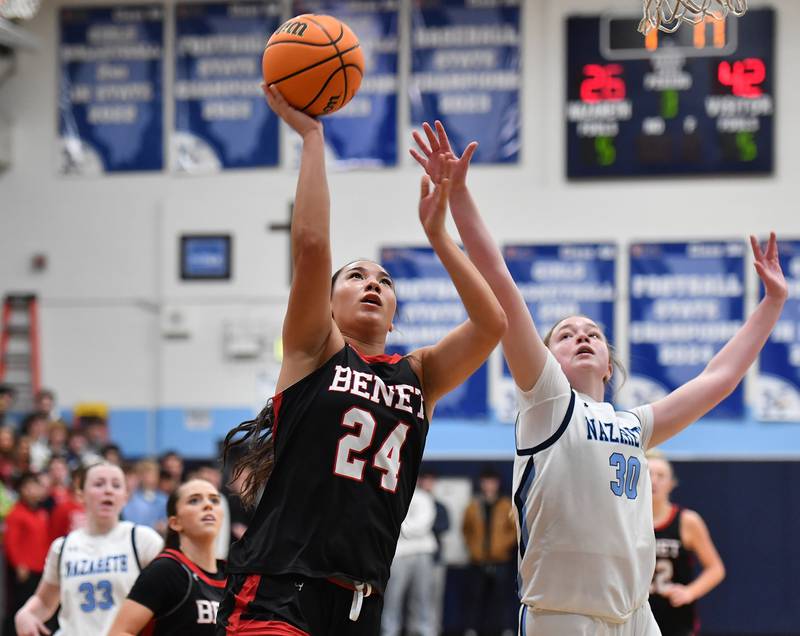 Benet’s Emma Briggs (24) lays the ball up as Nazareth’s Hillary Whorlow defends during a game on December 13, 2025 at Nazareth Academy in LaGrange Park.
