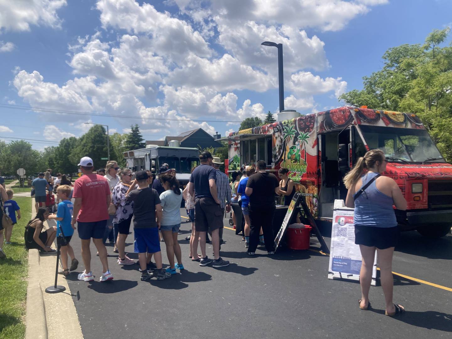 Guests line up outside the Tortuga Feliz Mexican food truck at the Plainfield Park District's Food Truck festival.