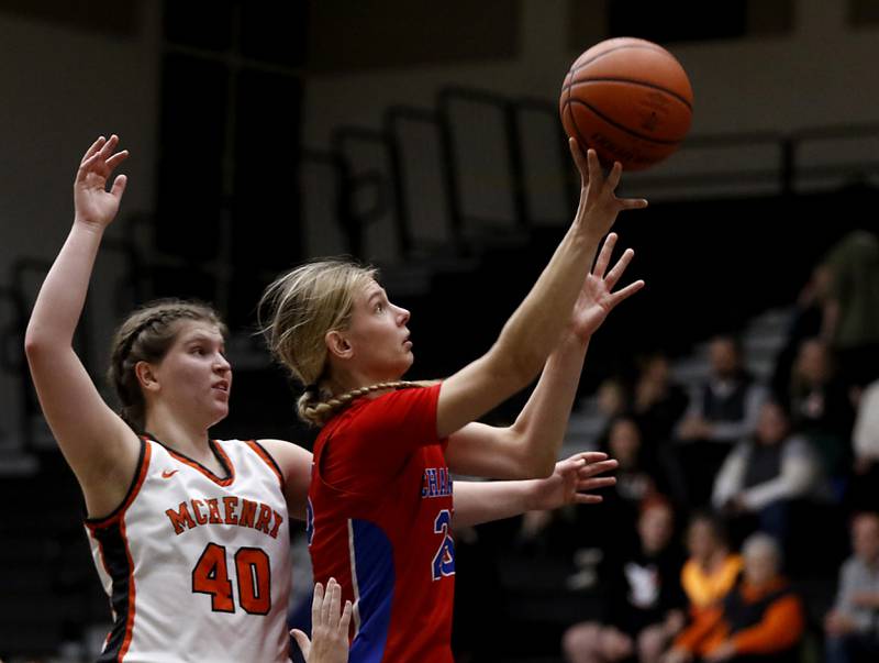 Dundee-Crown’s Monica Sierzputowski shoots the ball in front of McHenry's Erin Nothdorf  during a Fox Valley Conference girls basketball game on Tuesday, Dec. 12, 2023, at McHenry High School.