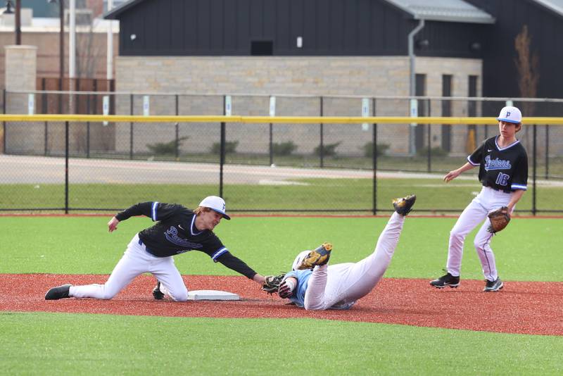 Peotone's Lincoln Tierney tags out Kankakee's Devin Arbour on a steal at second during their game on Friday, April 3, 2026.