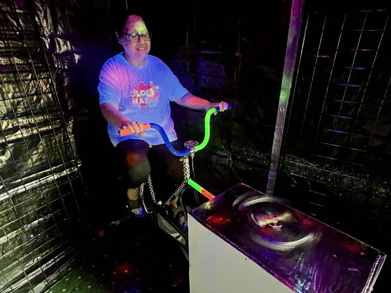 Sonia Robinson spins a canvas using a stationary bike at her art studio, Color Me Happy, in Sterling, Illinois.