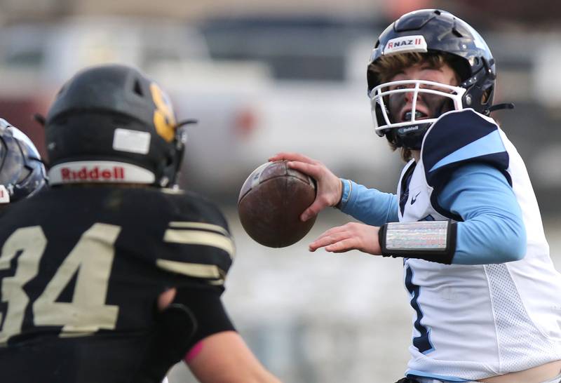 Nazareth's Logan Malachuk passes over Sycamore's Joey Puleo Saturday, Nov. 18, 2022, during the state semifinal game at Sycamore High School.