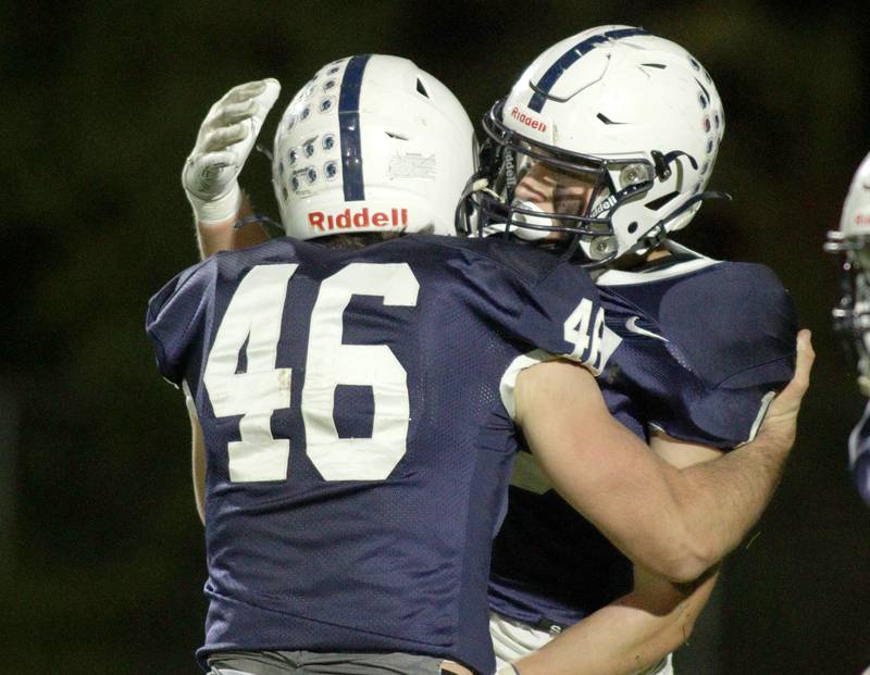 Cary-Grove’s Logan Abrams (46) and Jake Hornok celebrate after a touchdown against Libertyville in first-round Class 6A playoff  football action at Cary Friday.