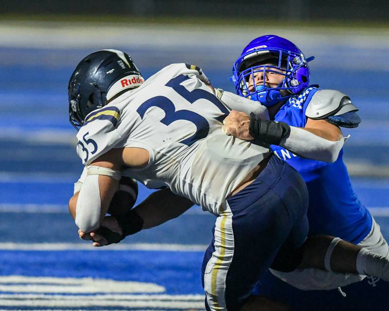 St. Francis's Preston Shipley (9) brings down IC  Catholic Prep's Jacob Reira-Cabrera (35) during the game on Friday Oct. 3, 2025, held at St. Francis.