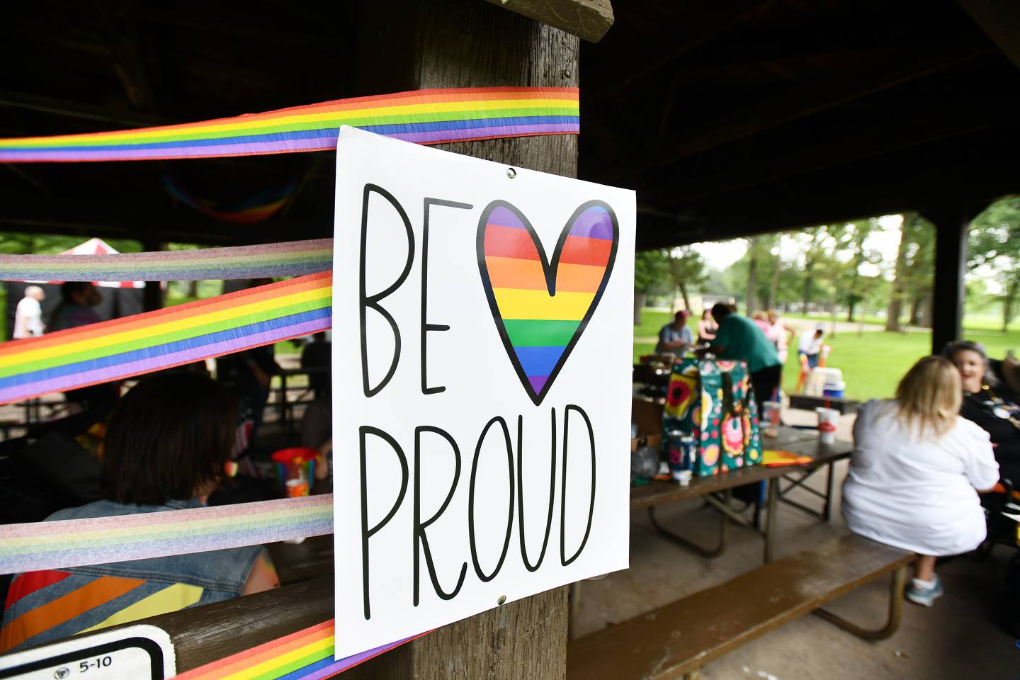Colorful streamers, signs and flags decorate the Kankakee River State Park's Main Pavillion as dozens gathered for the 2022 Kankakee Area LGBTQ Network's Pride Picnic.