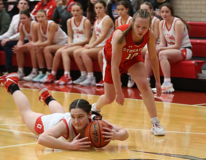 Ottawa's Mary Stisser dives for the ball while Streator's Ava Gwaltney backs off during the Lady Pirate Holiday Tournament on Wednesday, Dec. 20, 2023 in Kingman Gym.