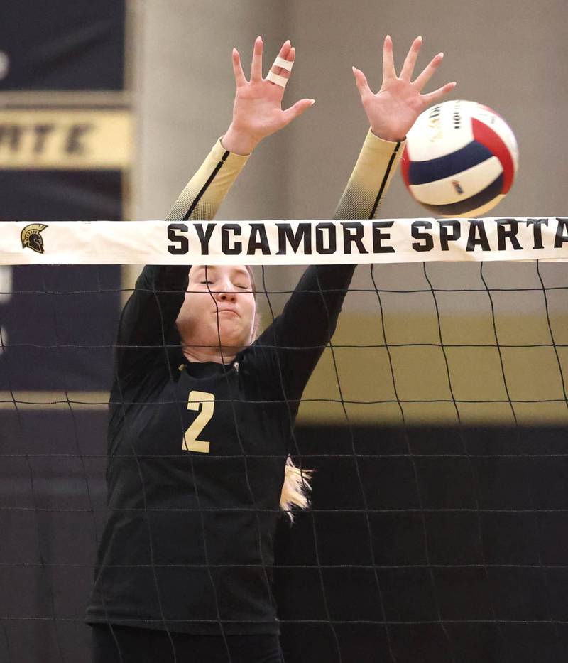 Sycamore's Madilyn Patton blocks a spike by Burlington Central Tuesday, Oct. 29, 2024, during their Class 3A regional match at Sycamore High School.