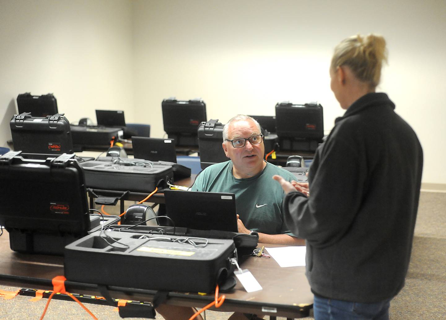 Election judge John Ulaszek, of Cary, talks with Meghan Honea, an election supervisor with McHenry County, as he practices using a voting machine Monday, May 16, 2022, at McHenry County Clerk's Office, 667 Ware Road, in Woodstock, as election judges are trained. Early voting starts for the primary election starts on Thursday, May 19, at the County Clerk's Office.