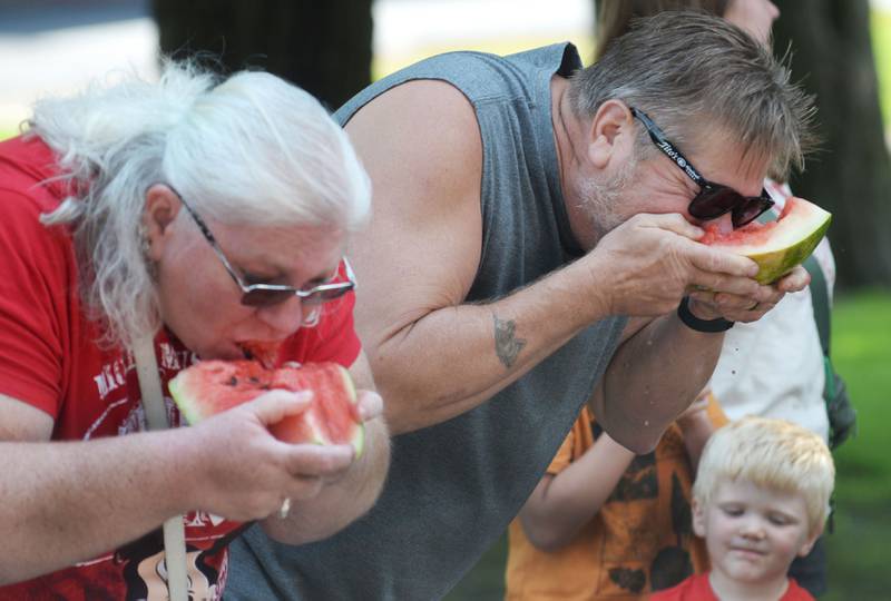 David Coy of Milledgeville (right) shows his winning gulping form as he eats watermelon in the adult division at Sauerkraut Days' watermelon-eating contest in Forreston on Saturday, Aug. 2, 2025.