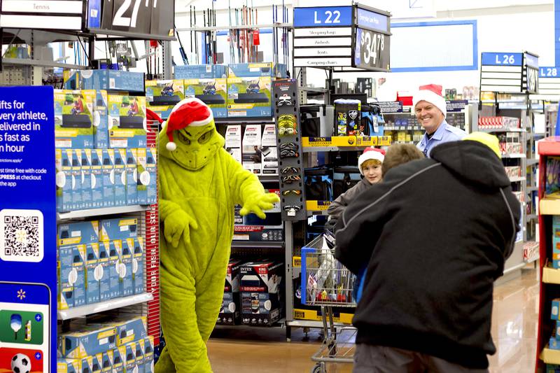 The Grinch was sneaking around Walmart and amusing children who were participating in the 36th annual Santa's Cops event on Saturday, Dec. 6, 2025, at Walmart, 401 Illinois Route 59, in  Shorewood.