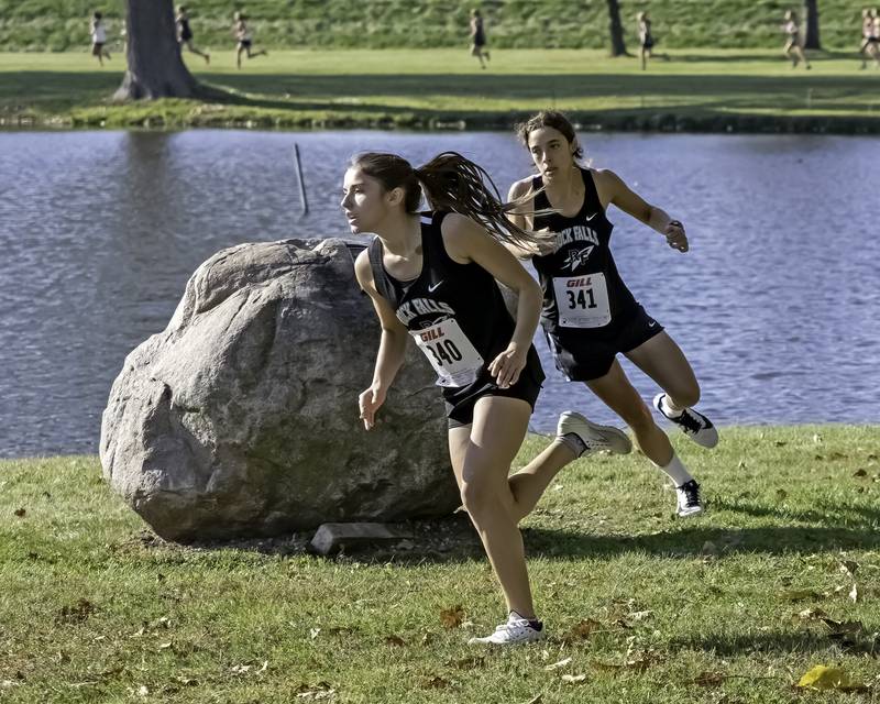 Rock Falls' Hana Ford (left) and Ariel Hernandez turn around the rock during the 1A Rock Falls Regional on Saturday morning at Centennial Park. Ford took third and Hernandez finished fourth to lead rthe Rockets to the team title.