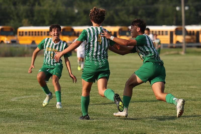 Providence’s JT Potocsnak, center, is greeted by Billy Savarino Jr and Simon Janakiev after his goal against Joliet Catholic on Aug. 21, 2023 in New Lenox.
