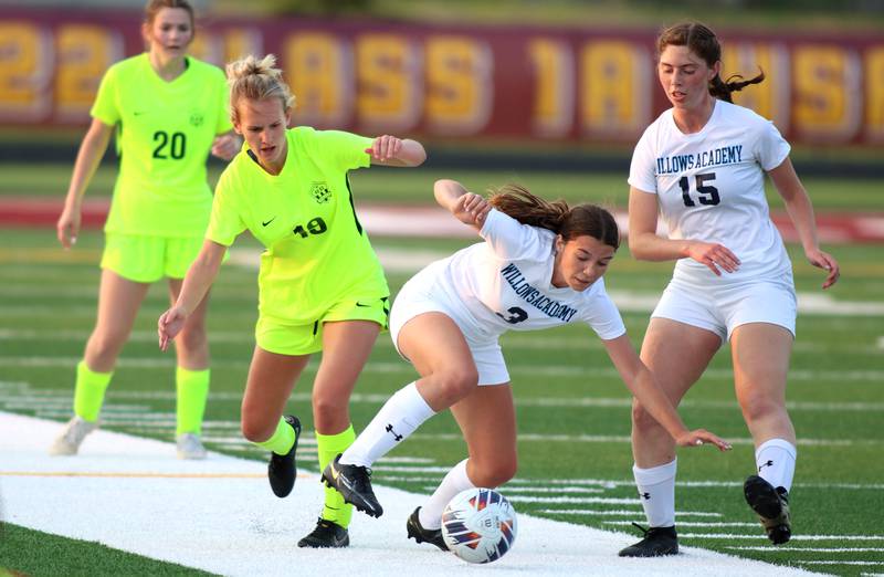 Richmond-Burton’s Layne Frericks, left, battles Willows’ Risi Carter in Class 1A Sectional title soccer action at Richmond Friday night.