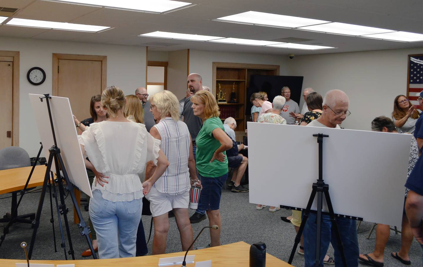 Mt. Morris residents examine the proposed redevelopment design for Zickuhr Park and discuss it with representatives of Hitchcock Design Group during an Aug. 1, 2023, community meeting. The village plans to apply for an Illinois Department of Natural Resources OSLAD grant for the project.