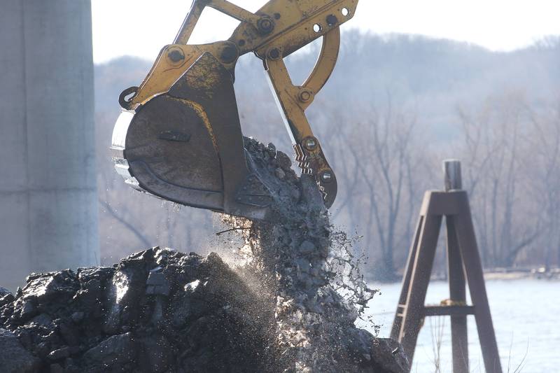 Silt and rock falls out of a clam bucket and on the shoreline of Barto Landing on Wednesday, March 26, 2025 in Spring Valley. Earlier this month, the Spring Valley City Council approved a proposal for $150,000 to dredge Barto Landing. River Docks Inc. of Peru was awarded the job. The city continues to pursue additional grant money to be reimbursed for the Barto Landing revitalization efforts.