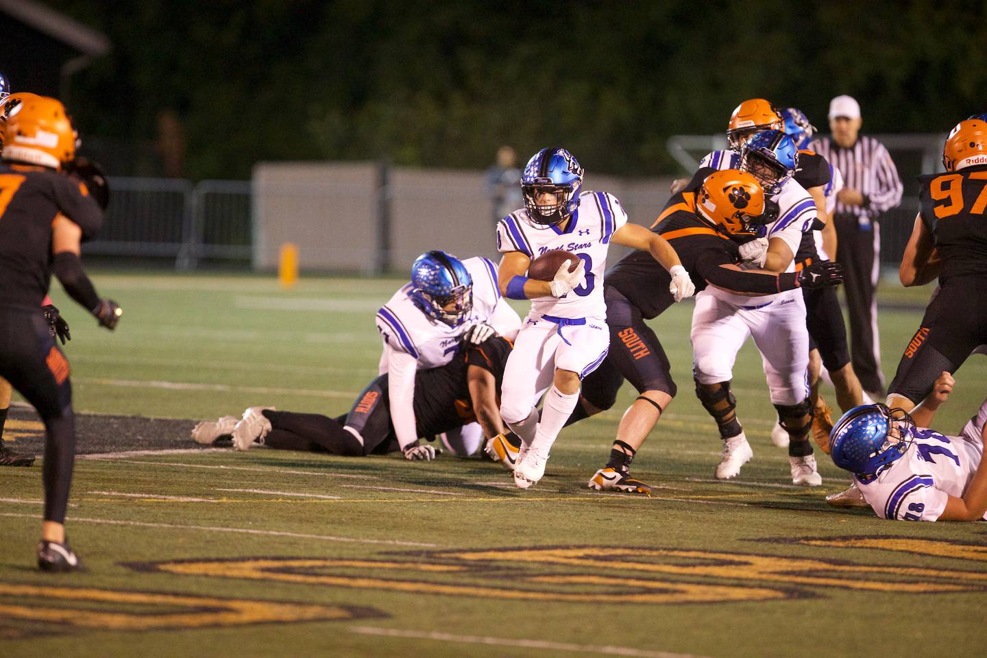 St. Charles North's Carsen Durante runs the ball for a gain against Wheaton Warrenville South on Friday, Oct. 10, 2025 in Wheaton.