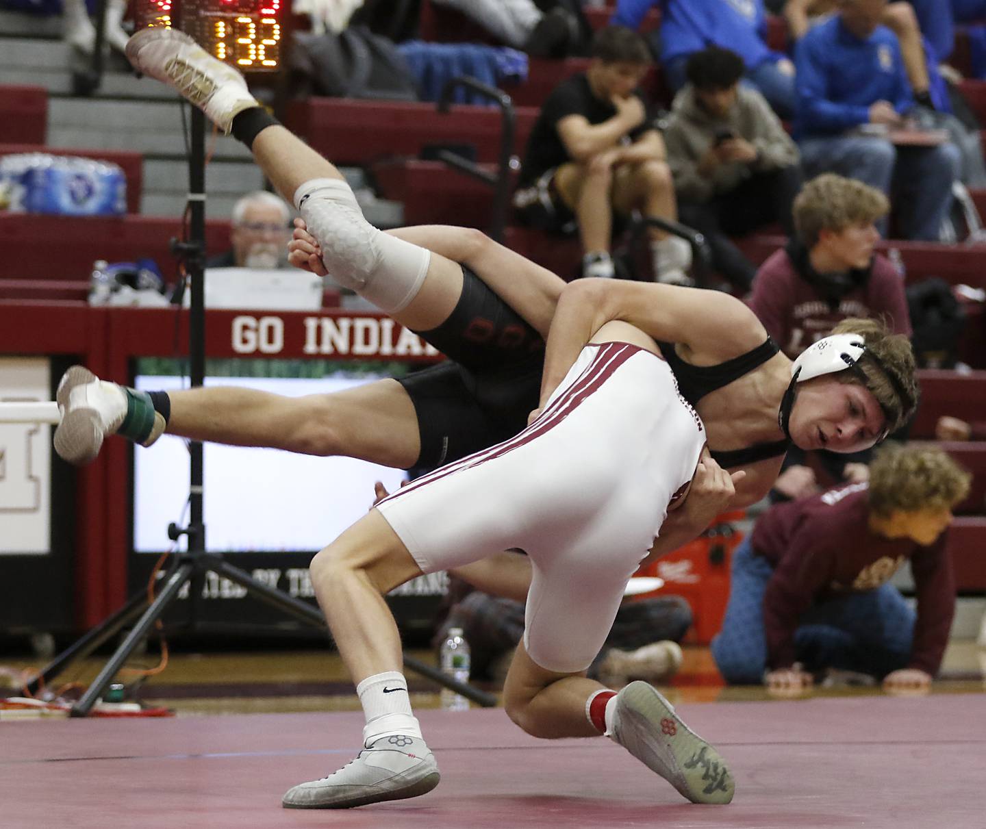 Marengo’s Hayden Beebe is tossed by (Wheaton Academy’s Lincoln Hoger in the 132-pound championship match of the IHSA 1A Marengo Wrestling Regional on Saturday, Feb. 8, 2025, at Marengo High School.