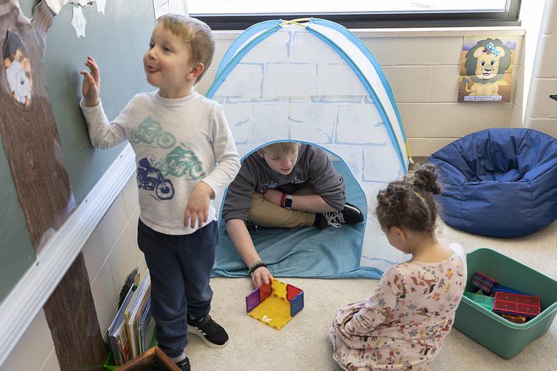 Newman Central Catholic High School sophomore Payton Hanna finds a perfect spot to play some games with 3-year-old Ty Olson and Evie Knapp on Thursday, Feb. 2, 2023 at St. Mary's School in Sterling. The school was recognizing Catholic Schools Week and National Day of Play by inviting the high schoolers to spend a few hours of uninterrupted fun and games with its youngest students.