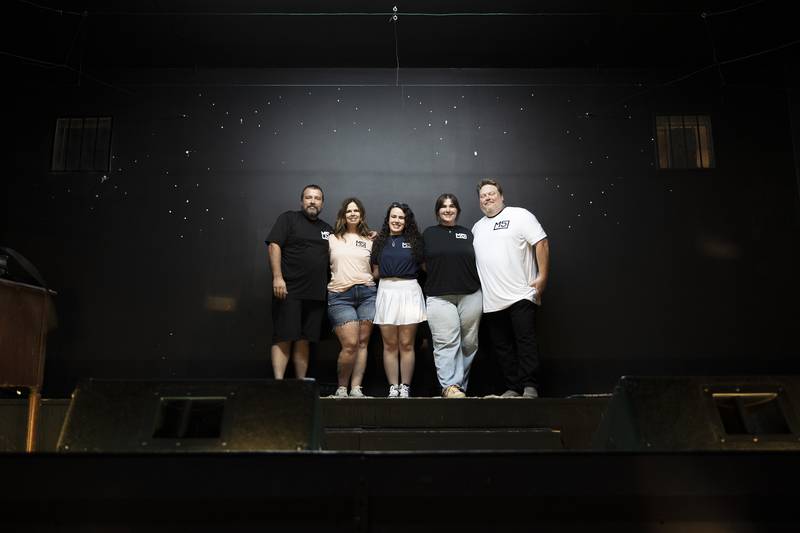 Rocky McGowan, with wife Darcie, daughters Cory and Carly, and Darren Mangler are shown on stage Thursday, July 10, 2025, at the soon-to-be Spark Center for the Performing Arts in downtown Sterling.