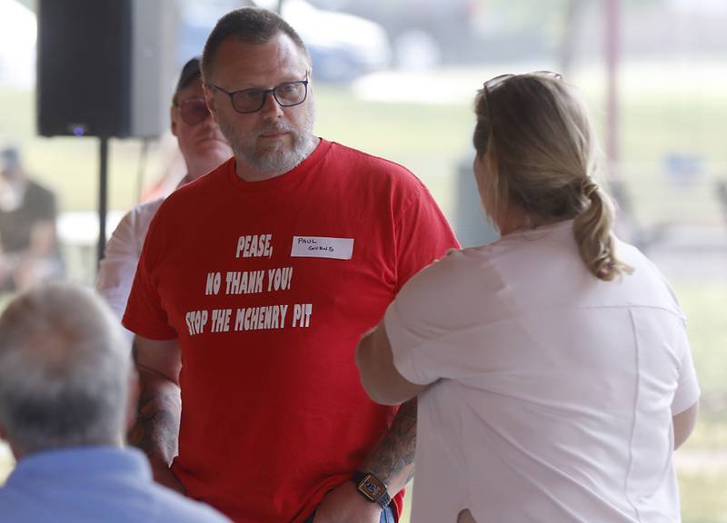 Paul Gurns listens to another viewpoint while speaking Wednesday, June 28, 2023, during a Stop the Pit Town Hall meeting at Veterans Park in McHenry. Over 150 people attend the town hall meeting to learn and voice their concerns about a proposed sand and gravel mining operation near McHenry.