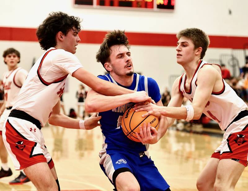 Hall's Noah Plym (left) and Luke Bryant smother Princeton's Gavin Lanham in the first half of Friday's Three Rivers game in Spring Valley. The Red Devils rallied in the second half for a 57-51 victory.