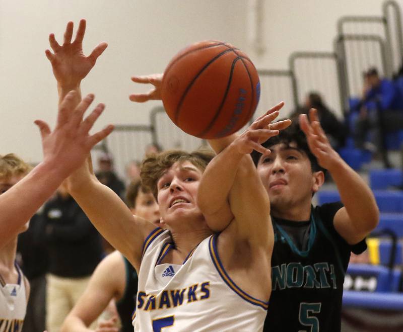 Johnsburg's Kyle Patterson batles with Woodstock North's Cesar Ortiz for a rebound during a Kishwaukee River Conference boys basketball game Wednesday, Jan. 18, 2023, at Johnsburg High School.