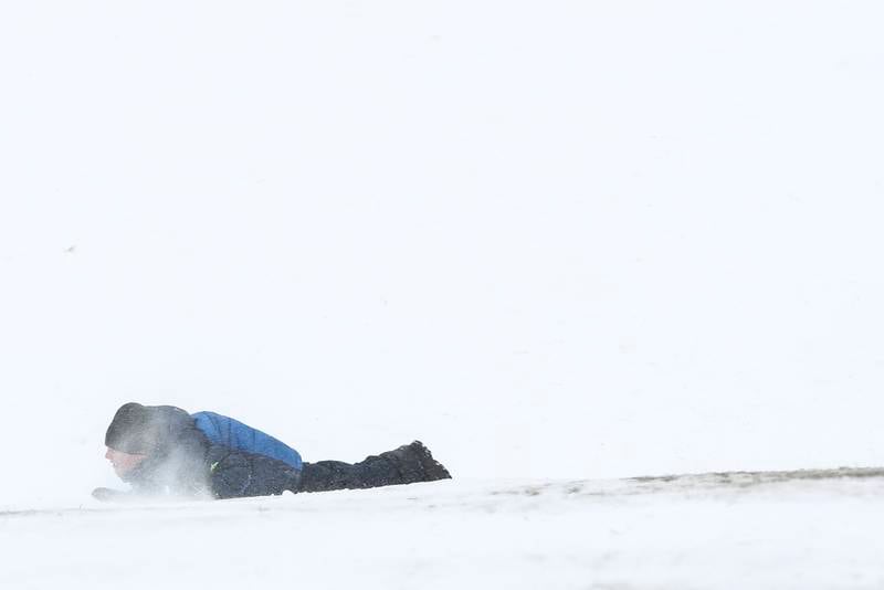 A sledder wipes out on Sunday, Jan. 31, 2021, at Cene's Four Seasons Park in Shorewood, Ill. Nearly a foot of snow covered Will County overnight, resulting in fun for some and challenges for others.