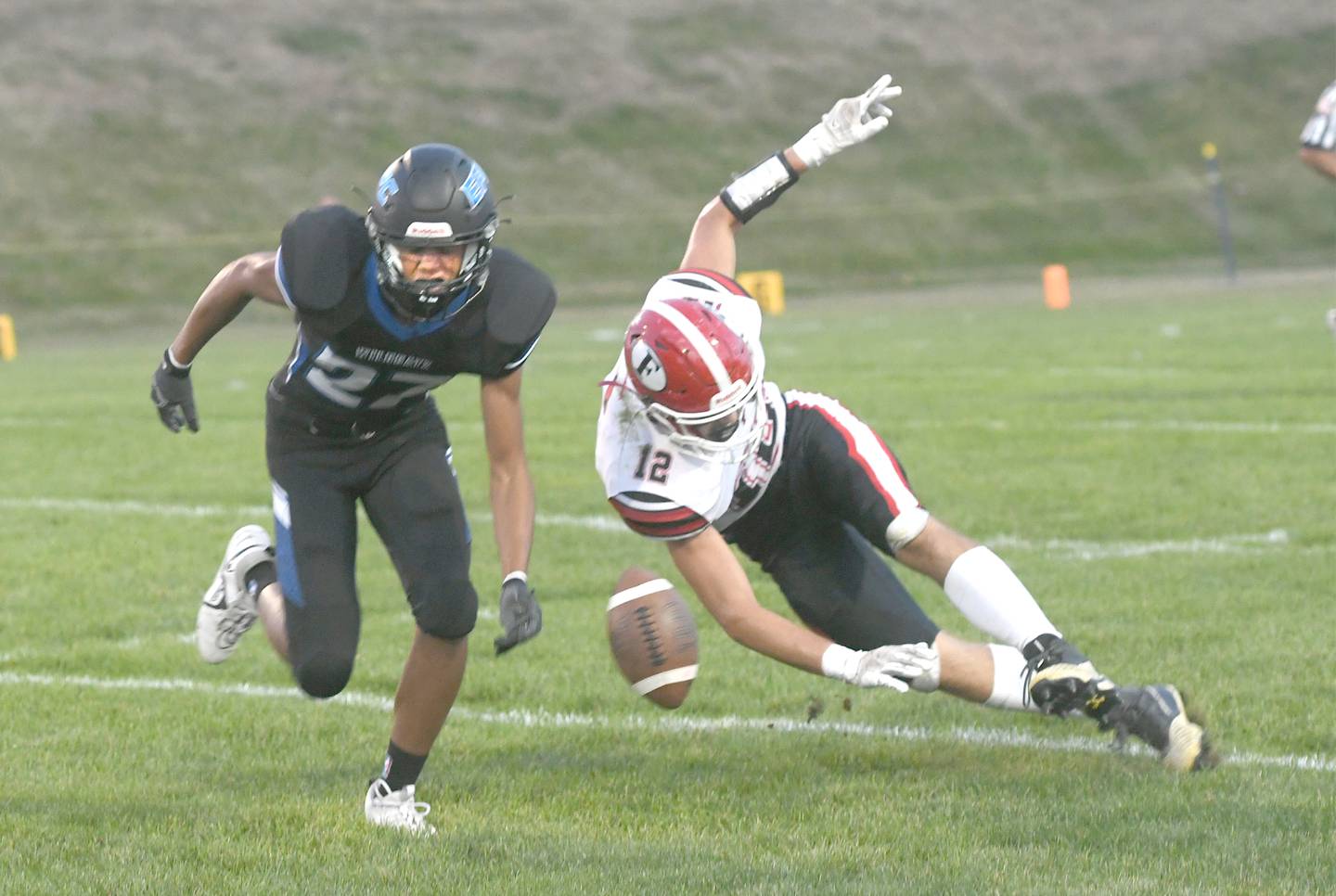 Forreston's Cole Becker reaches for a pass as Eastland's Donavan Kuhlemier defends.