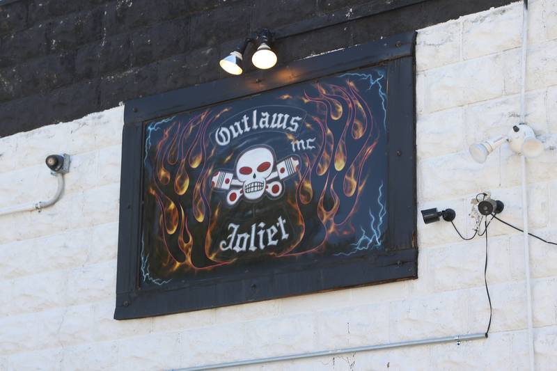 The Outlaws club sign hangs on the side of the clubhouse in Joliet. Tuesday, May 17 2022, in Joliet.