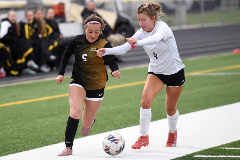 Herscher's Gianni Jaime, left, works past Manteno's Abby Thorne during a game at Herscher Tuesday, May 5, 2026.
