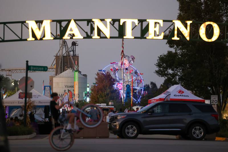 Carnival rides glow along Main Street in Manteno as the community gathered for the 27th annual Manteno Oktoberfest on Friday, Sept. 26, 2025.
