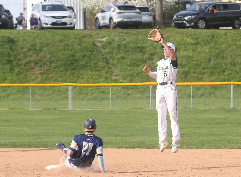 St. Bede's Sturart McGunnigal reaches up to make a catch as Marquette's Easton DeBernadi slides in safe on Thursday, April 24, 2025 at St. Bede Academy.