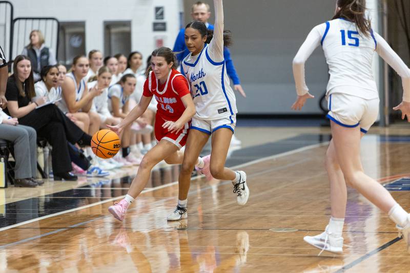 Batavia's Eva Holzl dribbles past St. Charles North's Sydney Johnson on Friday, Dec.12,2025 in st. Charles.