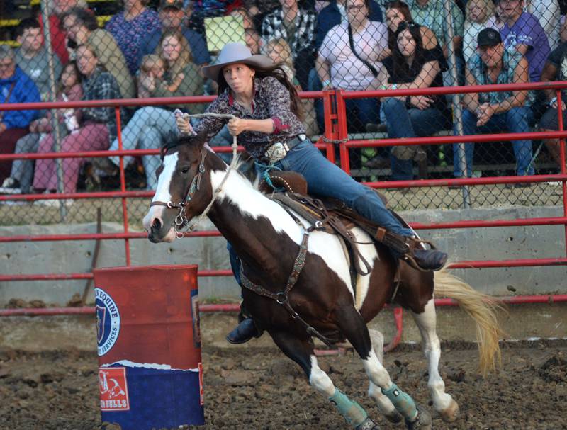 Quincy Hochstatter rounds the first barrel in one of the barrel racing divisions at the T & A Bucking Bulls Rodeo at the Ogle County Fair on Friday, Aug. 1, 2025 in Oregon.