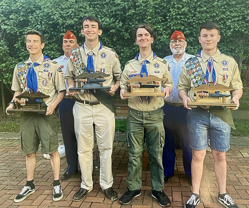 Tom Bulin (second from right) with the Fox Valley Marines presents four eagle scouts in Troop 26 with the ceremonial combat knife. Also pictured, Mark Hernandez of Oswego.