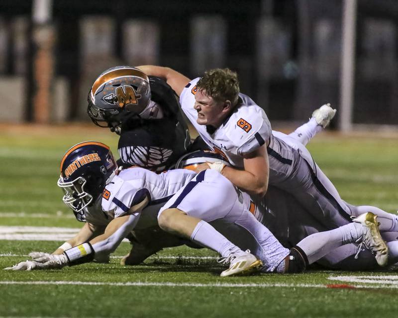 Oswego's Henry Smith (9) makes a big tackle without his helmet during football game between Oswego at Minooka.  April 23, 2021.