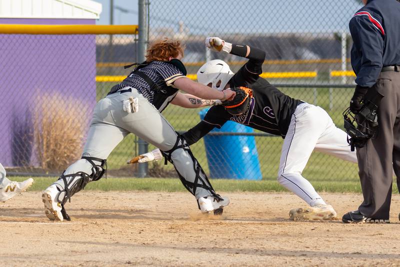 Payton Twait of Serena attempts to touch home base as Tommy Butler of Hiawatha attempts to tag him out on Monday, April 7, 2025 at Serena High School in Serena.