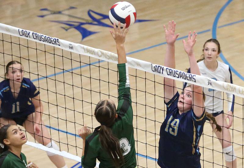 St. Bede's Hannah Heiberger sends a spike past Marquette's Kelsey Cuchra on Thursday, Sept. 4, 2025 at Bader Gym.
