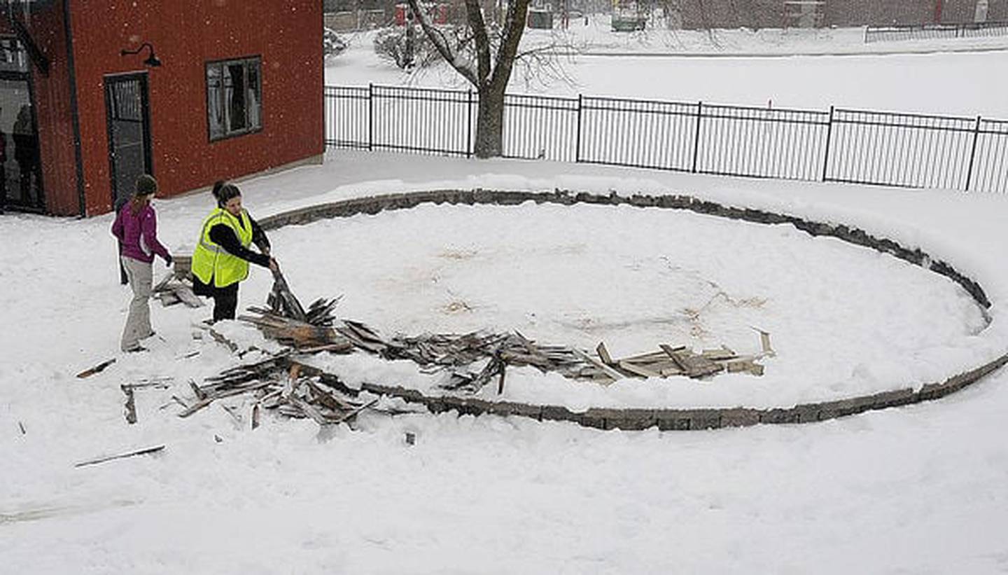 Kankakee High School student Alexis Zunke picks up some of the last remnants of the gazebo at Depot Park in Kankakee which was demolished by students in February 2015. The gazebo was a gift from David Letterman to the City of Kankakee.
