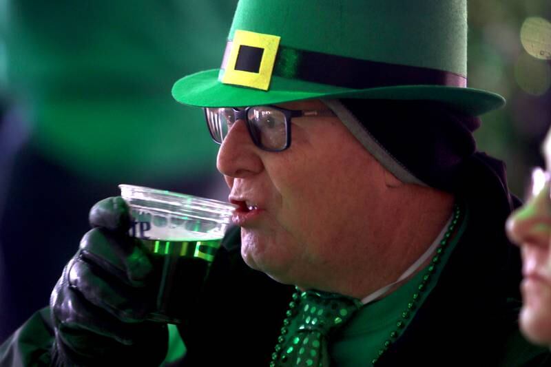Ralph Bailey of Lake in the Hills sips his green beer at the ShamROCKS the Fox Festival in McHenry Friday, March 17, 2023.
