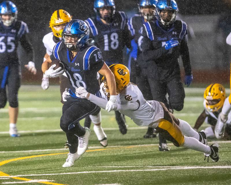 St. Charles North's Carsen Durante is tackled by Carmel's Carter Kasten at the Class 7A Second Round playoff game on Saturday, Nov.8,2025 in St. Charles.
