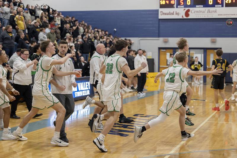 The Rock Falls bench storms the court after the Rockets won against Riverdale Friday, Feb. 28, 2025, during the Class 2A Regional final at Bureau Valley High School.