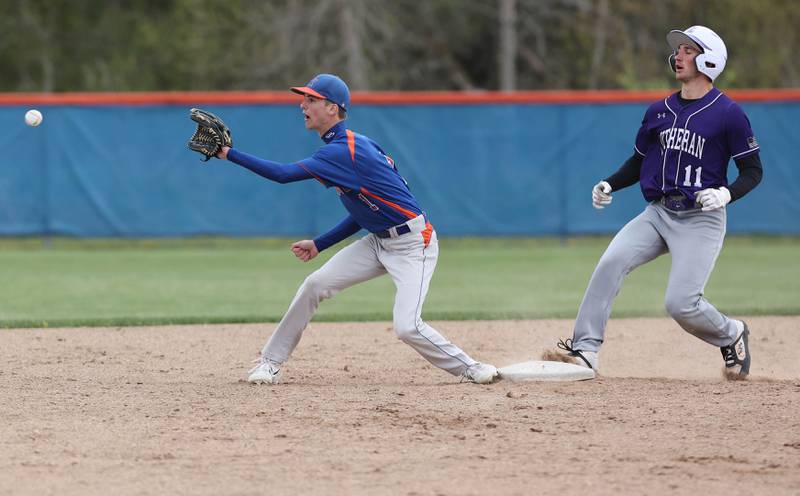 Genoa-Kingston's Connor Grimm takes the throw as Rockford Lutheran's Colin Courier comes in with a standup double during their game Tuesday, May 2, 2023, at Genoa-Kingston High School.