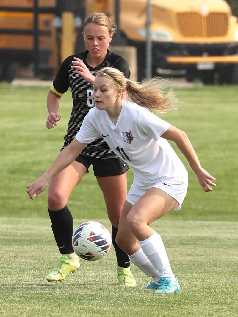 Prairie Ridge's Maria Falkowska carries the ball in front of Sycamore's Anna Lochbaum during their game Wednesday, May 17, 2023, at Sycamore High School.