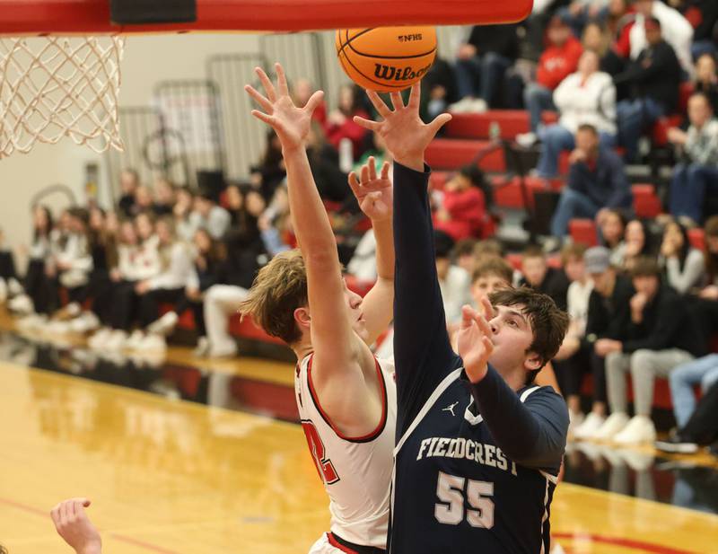 Fieldcrest's Kayden Elits runs in to score over Hall's Hunter Edgecomb during the Colmone Classic on Friday, Dec. 12, 2025 at Hall High School.