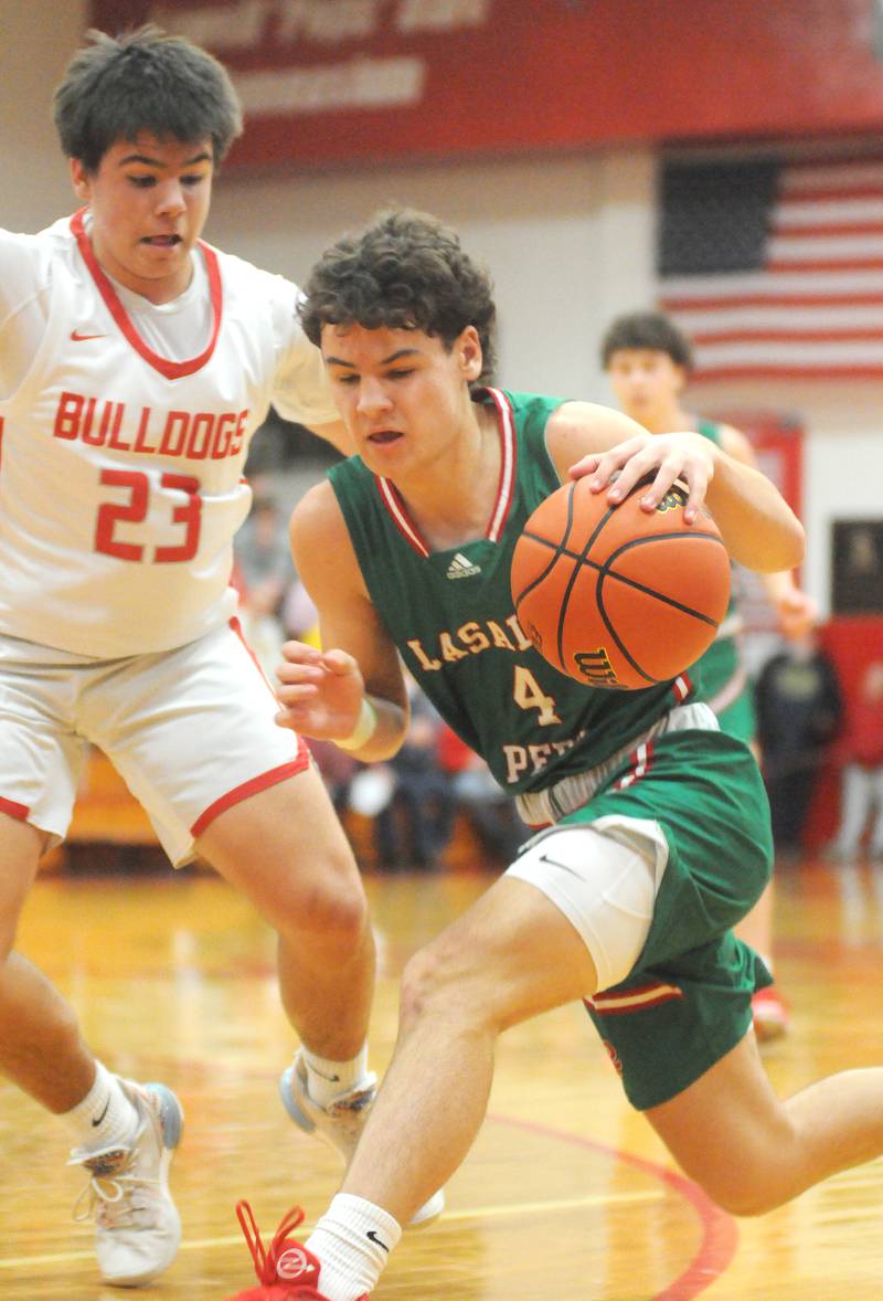 La Salle-Peru's Jack Jereb dribbles as Streator's Logan Aukland defends at Pops Dale Gymnasium on Friday, Jan. 26, 2024.