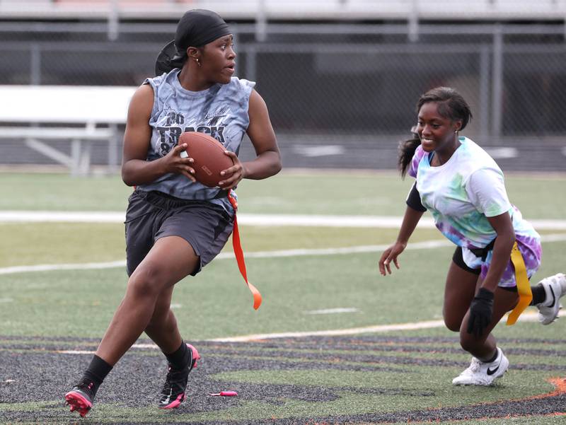 DeKalb’s Angela Gary rolls away from pressure Wednesday, Aug. 20, 2025, during the first practice of the DeKalb High School flag football team. The squad is preparing for their inaugural season.